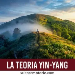 A person in a white shirt stands with arms outstretched on a misty mountain ridge at sunrise.