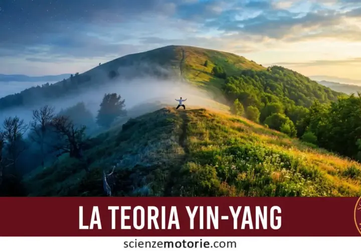A person in a white shirt stands with arms outstretched on a misty mountain ridge at sunrise.