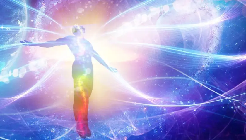 Silhouette of a person with arms outstretched, surrounded by colorful, swirling energy and cosmic elements.