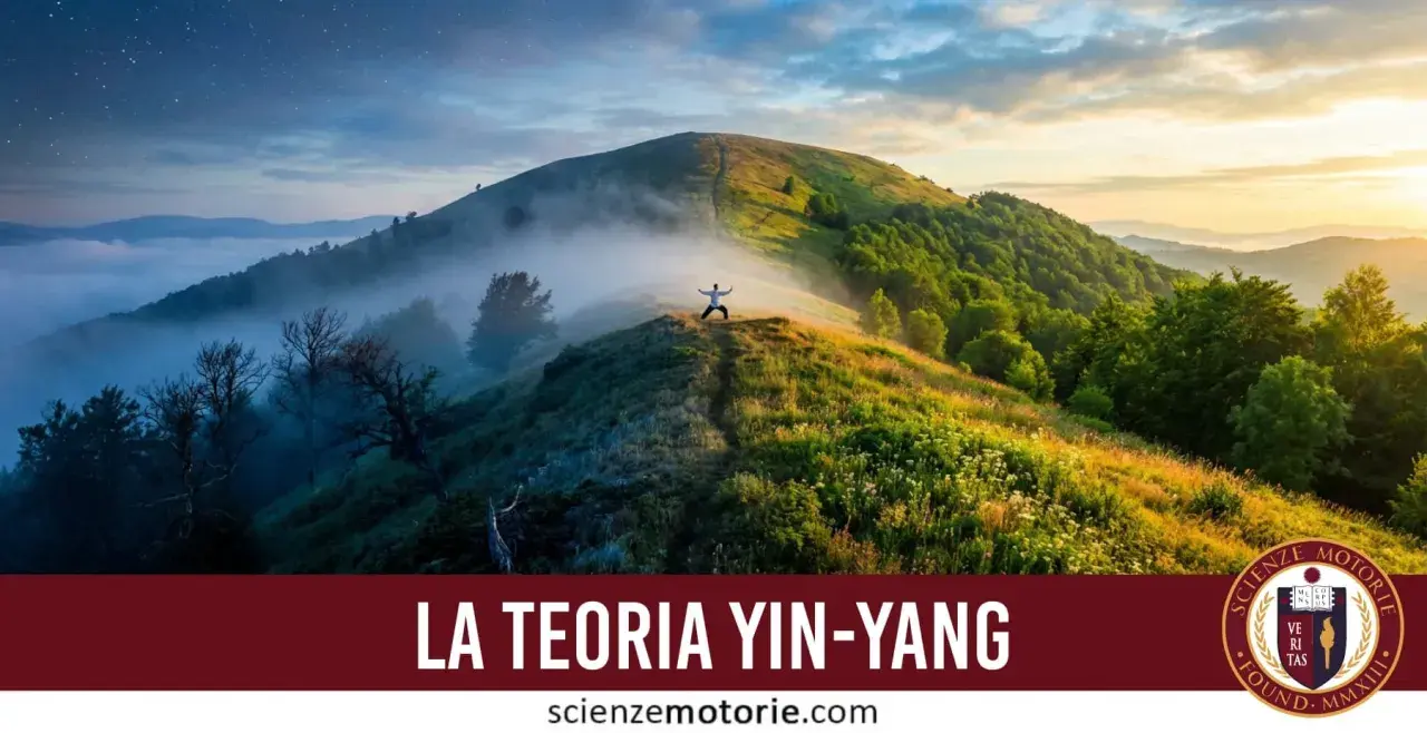 A person in a white shirt stands with arms outstretched on a misty mountain ridge at sunrise.