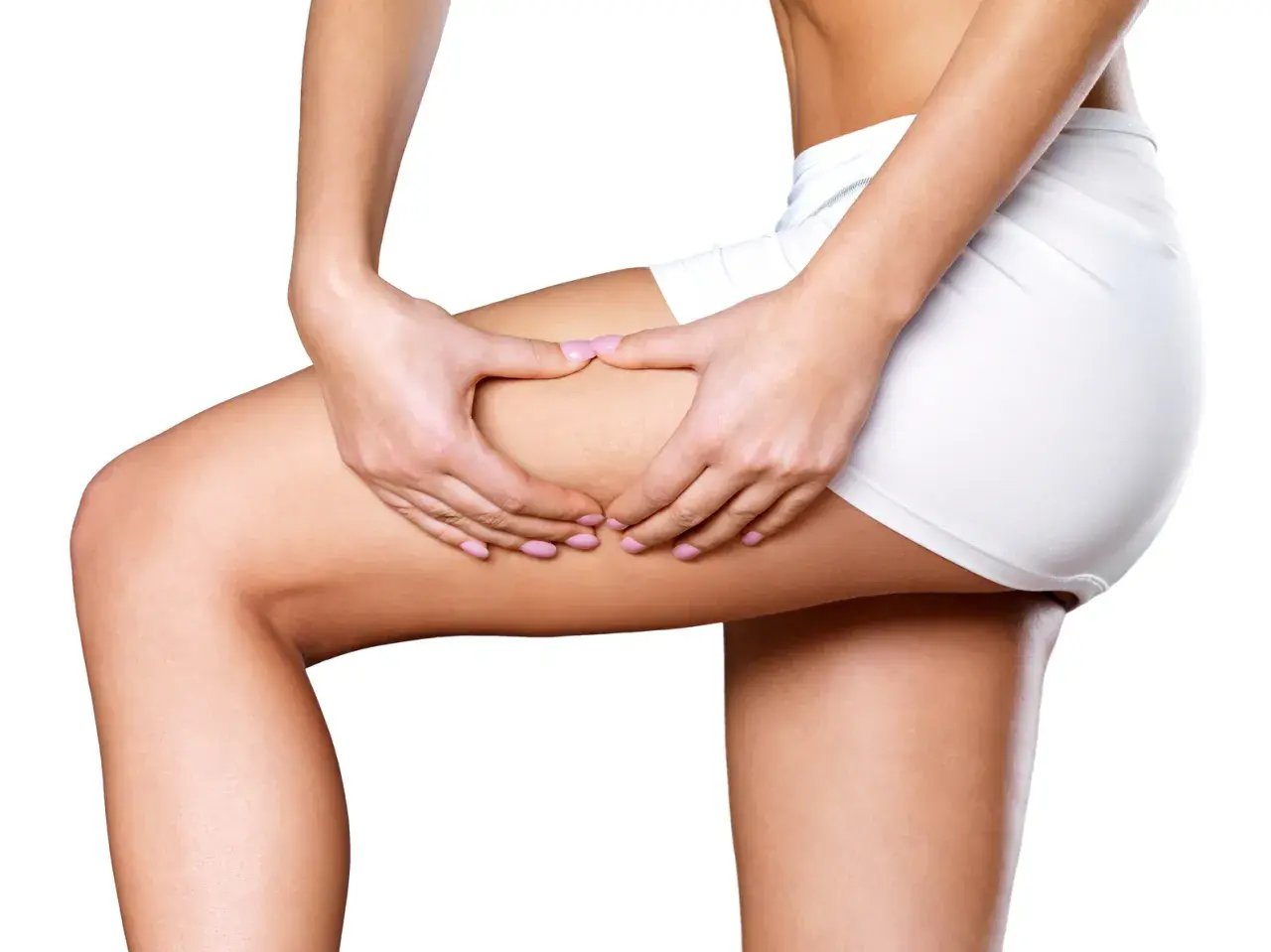 Woman's hands pinching thigh, showing skin texture.